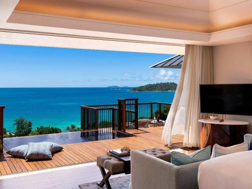 a living room with a view of the ocean at Raffles Seychelles in Baie Sainte Anne
