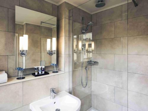 a bathroom with a shower and a sink and a shower at Mercure Oxford Eastgate Hotel in Oxford