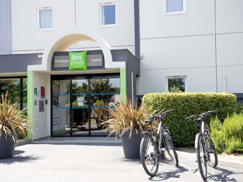 two bikes parked in front of a building at Ibis Styles Cognac in Châteaubernard