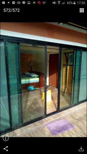 a view of a room with glass windows at Kaengkrachan River Hut in Kaeng Krachan