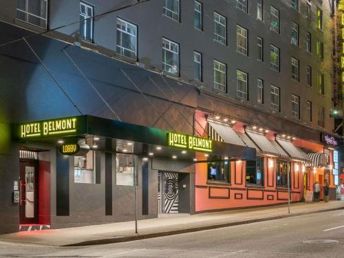 a building on a city street at night at Hotel Belmont Vancouver - MGallery Collection in Vancouver