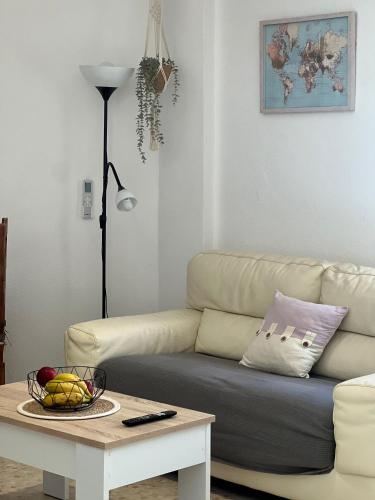 a living room with a couch and a table at Apartamento El Faro in Barbate