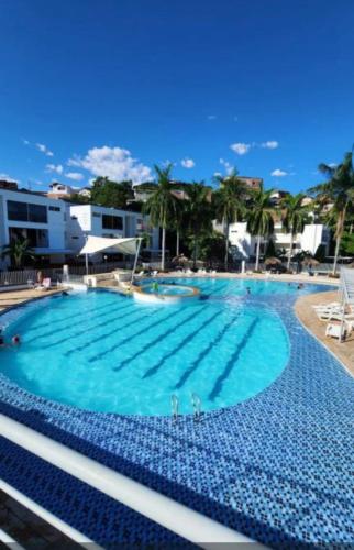 a large swimming pool with blue water at Ciudadela Santafe in Santa Fe de Antioquia