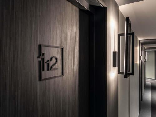 a hallway with a door with a picture on it at ibis Nancy Centre Stanislas in Nancy
