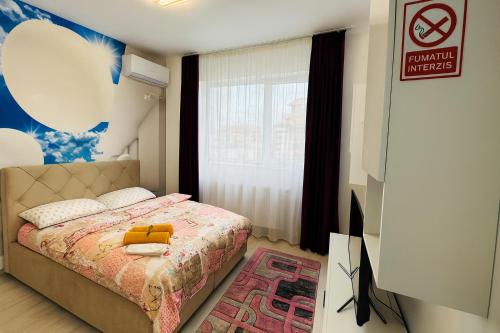 a bedroom with a bed with a yellow suitcase on it at Ho-Jack Dream Studio in Roşu