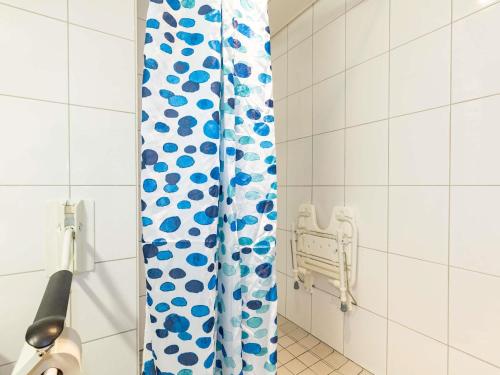 a shower curtain with blue and white polka dots at ibis budget Zurich City West in Zürich