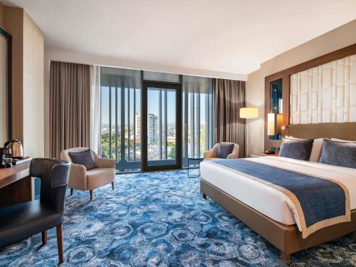 a hotel room with a bed and a desk at Tbilisi Philharmonic Hotel by Mercure in Tbilisi City