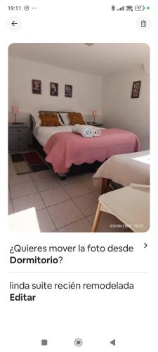 a bedroom with two beds with pink sheets at Lindo depto cercano a la playa in Guanaqueros