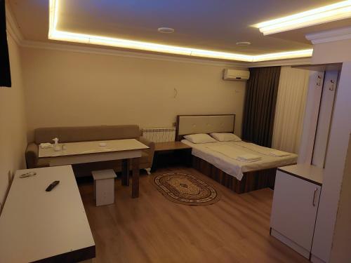 a small room with a bed and a table at Elit Hotel in Mingachevir