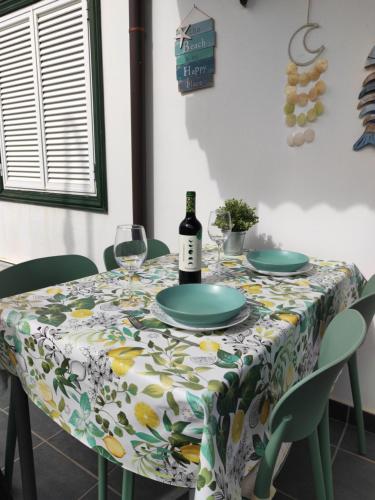 a table with a bottle of wine and glasses on it at Villa JALD in Abades
