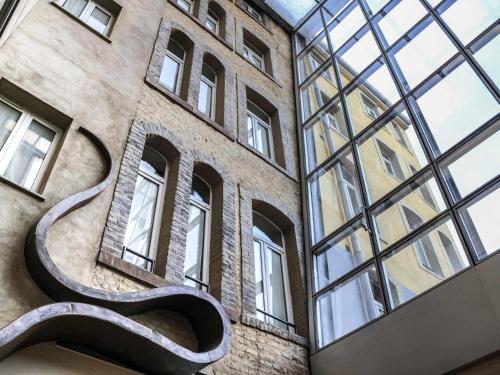 a building with a sculpture on the side of it at Mercure Strasbourg Centre Gare in Strasbourg