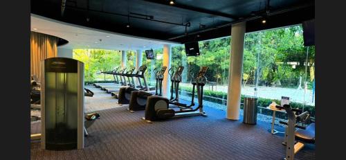 a gym with a row of treadmills in a building at El Paseo Tambuli in Maribago