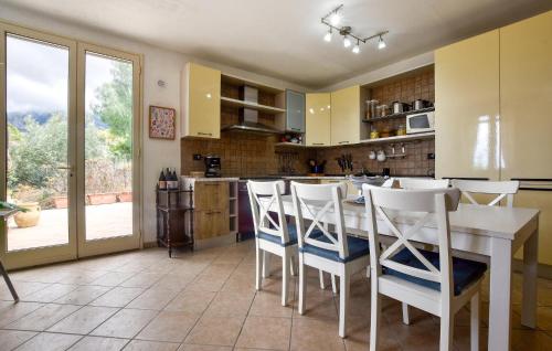 a kitchen with a table and chairs and a large window at Gorgeous Home In Caccamo With Private Swimming Pool, Can Be Inside Or Outside in Caccamo