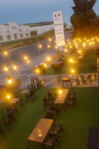 a group of tables and chairs at night with lights at HOSTAL LAS PALOMAS in Lucena