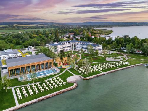 an aerial view of a resort next to a body of water at Mövenpick Balaland Resort Lake Balaton in Szántód