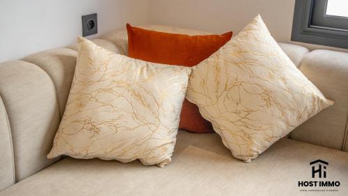 two pillows sitting on top of a couch at Apartment - Mehdia Beach in Kenitra