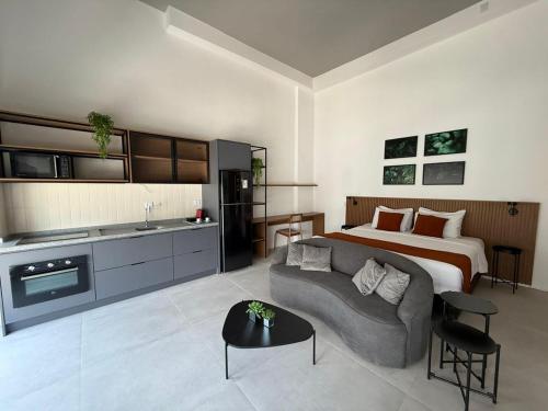 a bedroom with a bed and a couch in a room at Residence X in Sao Paulo