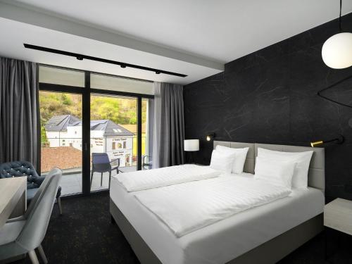 Ένα ή περισσότερα κρεβάτια σε δωμάτιο στο Mercure Tokaj Center