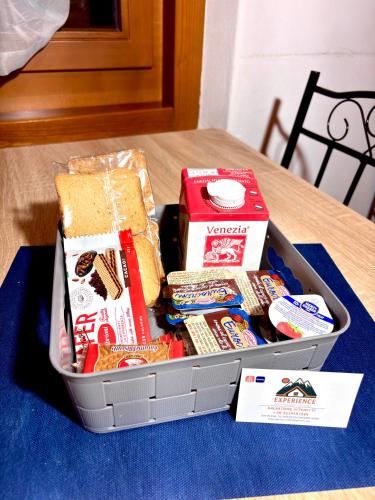 a lunch box on a table with sandwiches and snacks at Casa Experience - Venas Di Cadore in Venas