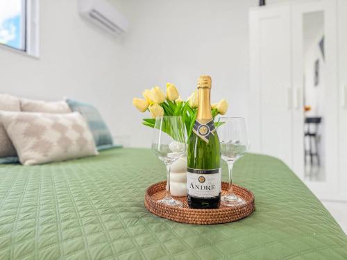 a bottle of champagne and glasses on a table at Luxury Suite Studio With Kitchen & Spa Shower in Lake Lucerne