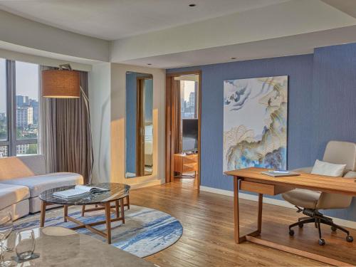 a living room with a couch and a table at Novotel Suites Manila at Acqua in Manila