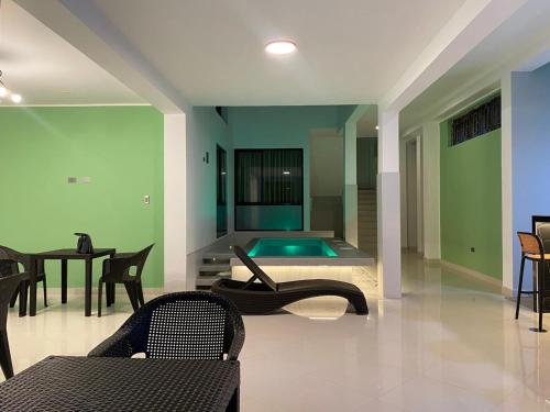a living room with a pool and a table and chairs at Hotel Raymondi in Tarapoto