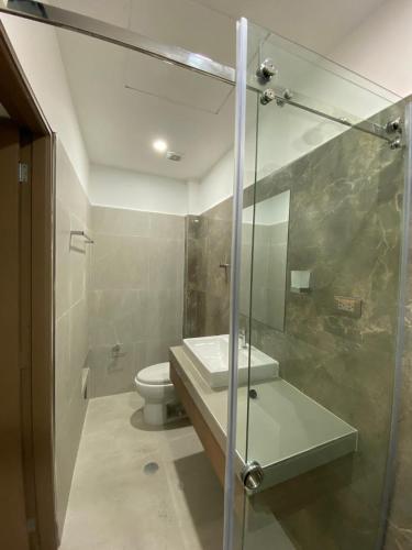a bathroom with a sink and a toilet at Hotel Raymondi in Tarapoto