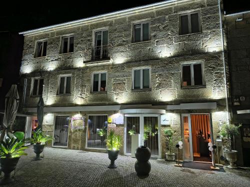 a stone building with lights on it at night at 4youhouse in Viseu