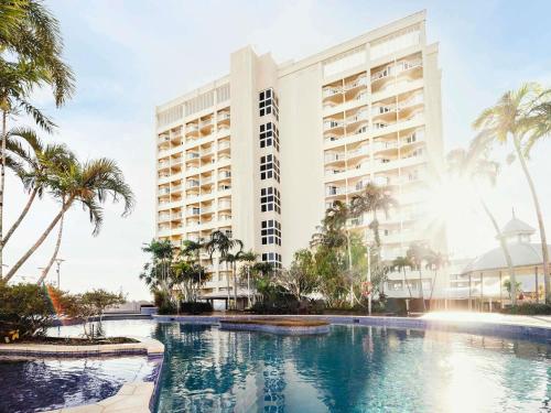 a rendering of a hotel with a swimming pool and palm trees at Pullman Cairns International in Cairns