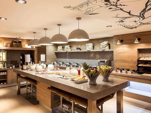 a kitchen with a large island in the middle at ibis Edinburgh Centre South Bridge – Royal Mile in Edinburgh