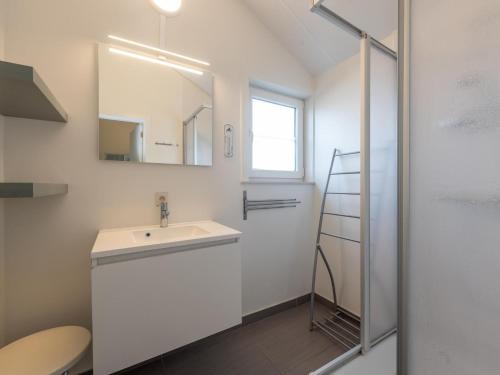 LombardsijdeにあるZee en Polder H138の洗面台と鏡のある白いバスルーム