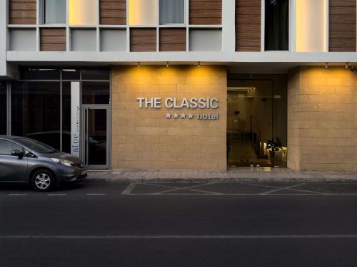 a building with a sign on the side of it at The Classic Hotel Nicosia - Handwritten Collection in Nicosia