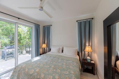 a bedroom with a bed and a large window at Wyakha 1 Garden View in Long Bay Hills