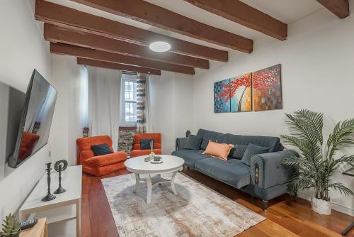 a living room with a couch and a table at Spacious 2BR Downtown - Vintage Charm Sleeps 10 in Montréal