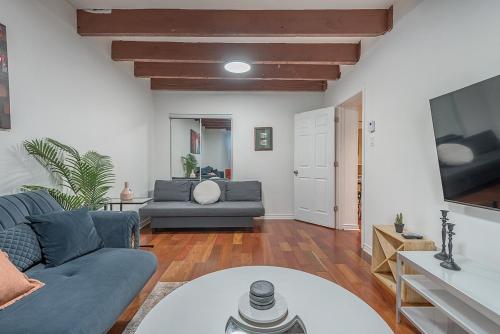 a living room with a couch and a table at Spacious 2BR Downtown - Vintage Charm Sleeps 10 in Montréal