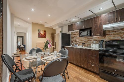 a kitchen with a table and chairs in a kitchen at Spacious 2BR Downtown - Vintage Charm Sleeps 10 in Montréal