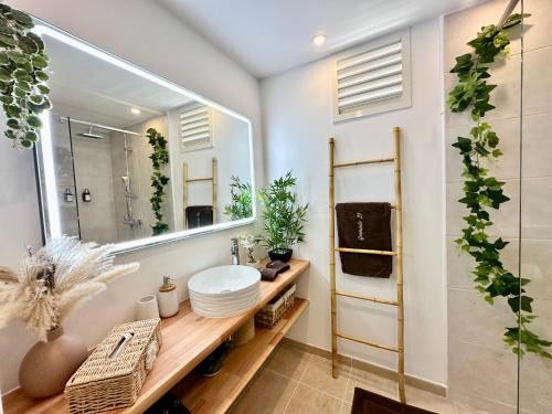 a bathroom with a sink and a mirror at Grenade 21 vue mer proche plage dans Complexe type Village Vacances in Sainte-Luce