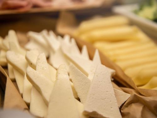 a close up of cheese on a tray of food at The Classic Hotel Nicosia - Handwritten Collection in Nicosia