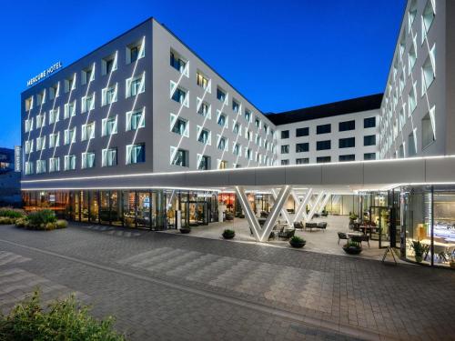 a view of a building with a lit up facade at Mercure Debrecen in Debrecen