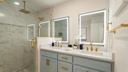 a bathroom with a double sink and a shower at Luxury 3 Bdr Edmond, Fuseball, Pac-man, Sleeps 9 in Edmond
