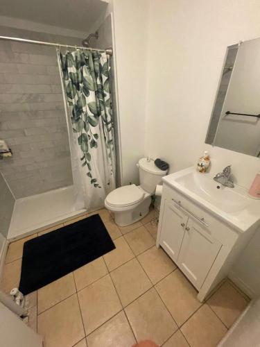 a bathroom with a toilet and a shower and a sink at THE BLOOR AC SUITE-Free Wifi-Train-Bus Stop Next Door in Toronto