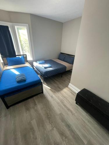 a small room with a bed and a couch at THE BLOOR AC SUITE-Free Wifi-Train-Bus Stop Next Door in Toronto