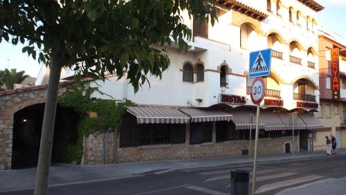 
a large building with a clock on the side of it at Hostal Miryam in L'Escala
