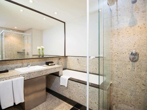 a bathroom with a sink and a shower at Pullman Sao Paulo Vila Olimpia in Sao Paulo