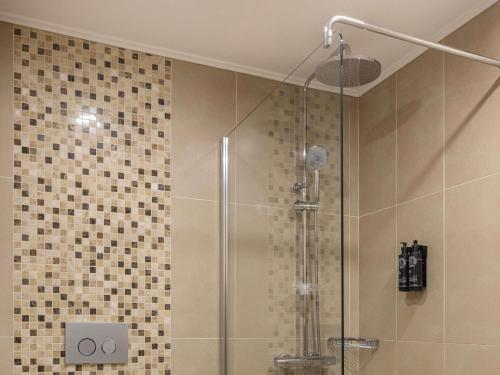 a shower with a glass door in a bathroom at Mercure Ankara Kızılay in Ankara