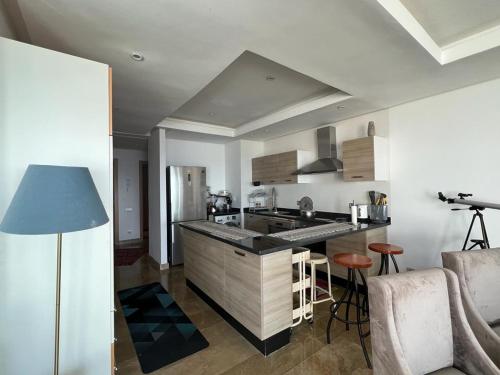 a kitchen with a sink and a counter top at Luxurious Seaside Apartment in Sidi Bouqnadel