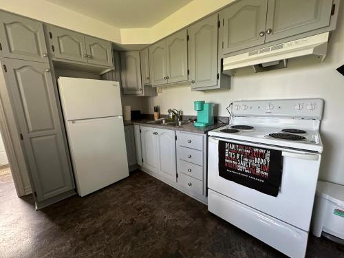 a kitchen with white appliances and a white refrigerator at City View Charm St John's 1br, 8min To Downtown in Port Rexton