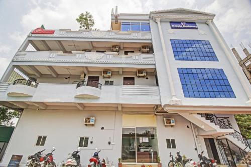 a building with motorcycles parked in front of it at Hotel O A Delight Residency in Surūrnagar