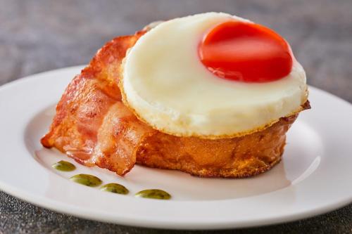 a piece of food on a plate with a cherry on top at Kamenoi Hotel Aso Park Resort in Aso