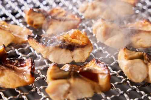 a bunch of food cooking on a grill at Kamenoi Hotel Aso Park Resort in Aso